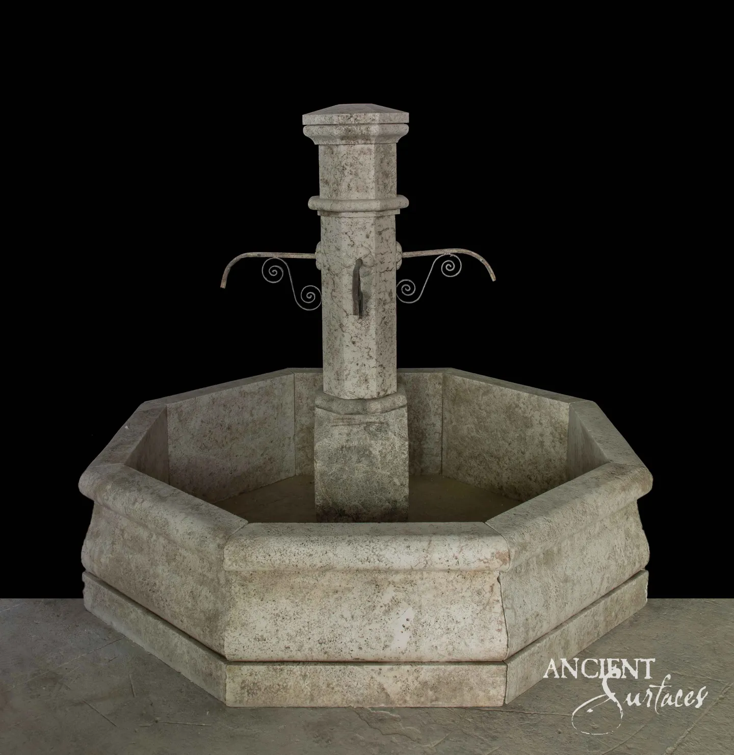 Octagonal limestone pool fountain with a square column and scrolled wrought-iron spouts