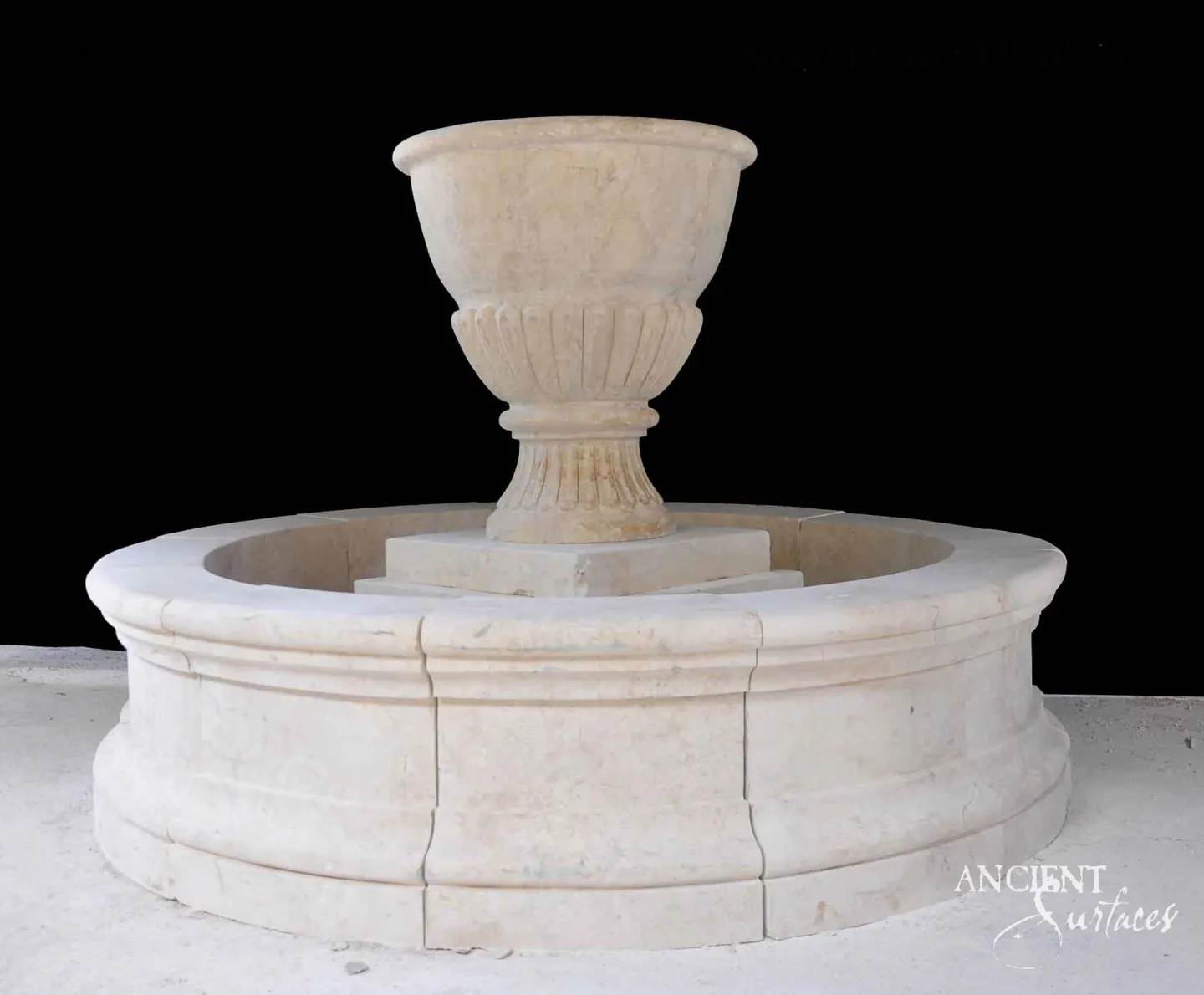 Round cream limestone pool fountain with a fluted carved urn centerpiece