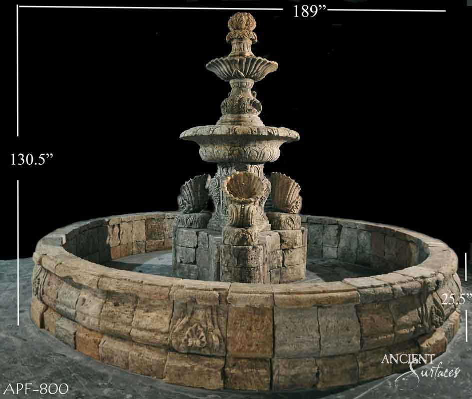 Monumental two-tier round limestone pool fountain with shell spouts and a pinecone finial